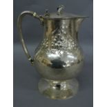 Omar Ramsden & Alwyn C.E. Carr - Baluster shaped chased silver jug with reeded knot handle, scroll