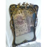 A good Art Nouveau Jesso and gilt wall mirror with shaped sides with decoration of trees growing