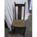 Arts and Crafts oak Rocking Chair with marquetry inlay to bar back and splat of flowers with rush