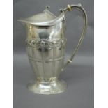 Omar Ramsden & Alwyn C.E. Carr - oval chased silver stylish jug with fold over rim, Celtic and panel