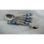 Archibald Knox for Liberty & Co - four silver and blue green enamel tea spoons and sugar tongs,