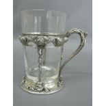 Omar Ramsden - A silver tea glass holder with original clear glass, the holder having decoration