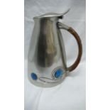 Archibald Knox for Liberty & Co. pewter hot water jug with swelling conical body, cane handle and