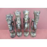 Four 19thC African carved wooden grotesque figures height 8.5ins