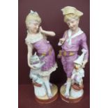 Pair of late 19thC French Bisque porcelain figures of a boy with dog and girl with cat - height 15.
