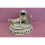 19thC Oriental brass lion dog holding a torch on a pedastal height 8.5, width 10.5ins