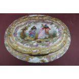 An oval porcelain box with ormolu fittings having painted and transfer scene to top and sides of