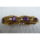 A good 18 ct. gold amethyst bracelet with bark finish and 15 cts. of amethysts each dtone diam 8mm -