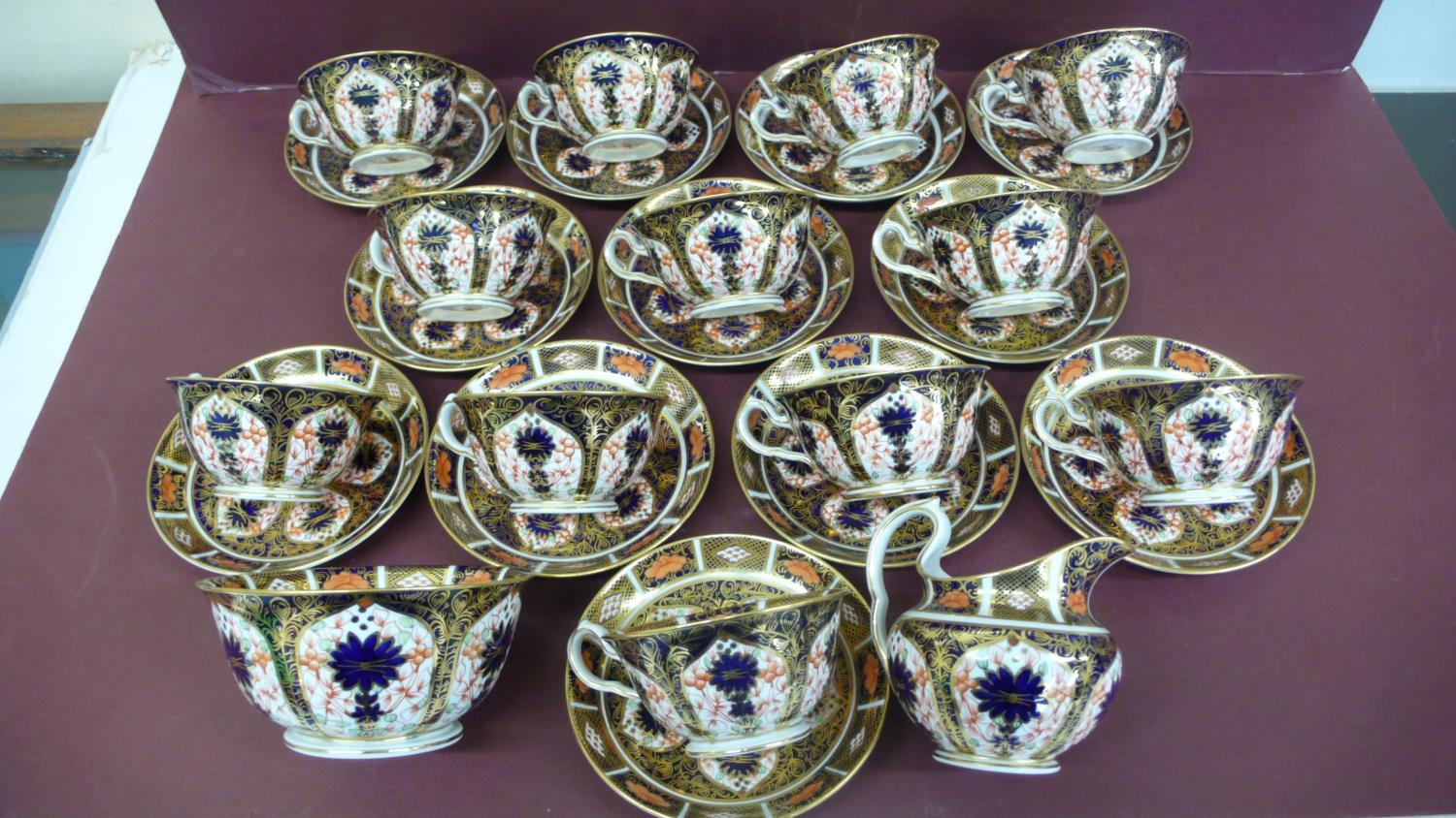 A set of twelve Royal Crown Derby Imari pattern tea cups, saucers, milk jug and sugar basin -