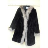 Ladies reversible shower proof cropped black mink mid length coat with hood having silver fox fur