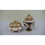 Two Royal Crown Derby Imari pattern urns with finials - tallest 4.5 ins - 1920 & 1939