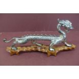 Chinese silver plated metal dragon on purpose built hardwood stand - length 13 ins