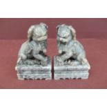 Pair of Chinese carved grey figured soap stone lion dogs on pedestals - height 5.5ins