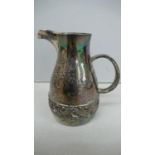 A designer silver cream jug with decoration of of a belt of acorns, oak leaves, fearns and toad