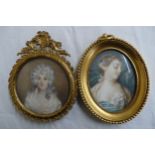 Two French miniatures of beauties in brass frames - oval - ht. 3.5 ins