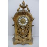 19thC French ormolu mantel clock with flaming urn finial to dome top, enamel numerals to brass dial,