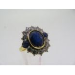 An oval sapphire and diamond cluster ring 2.5 ct. sapphire and 1.2 cts. of diamonds set in gold -