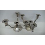 A pair of designer silver three branch candelabra with three reeded arms on circular base.