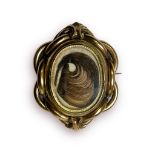 Large Victorian yellow metal mourning brooch displaying locks of hair to the front, and petals to