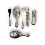 A seven-piece silver-backed dressing table set by Henry Matthews, comprising brushes, a mirror, a