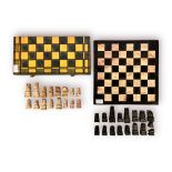A soapstone chess set and board, together with another chess set, with carved wooden board and
