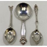 A silver caddy spoon with acorn pattern finial by Georg Jensen, together with two silver