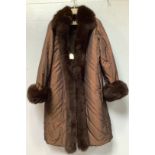 A lady’s satin and brown fur trimmed three quarter length coat, by Yves Salomon