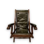 A late 19th / early 20th century stained mahogany folding campaign chair, buttoned green leather