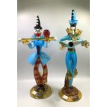 Two handmade Murano glass figures, one modelled as a smiling clown balancing a red sphere on a