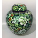 A cloisonné enamel ginger jar and locking cover, green floral decoration, marked to base, approx.