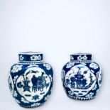 A pair of Chinese blue-ground ginger jars and covers, decorated with flowers and scenes of