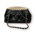 A Chanel vintage black aged calfskin leather and cream quilted handbag, grey fabric interior, with