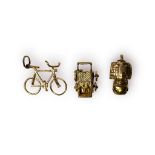 Three 9ct gold charm/pendants, including a bicycle, a pram, and a old woman in a boot house, total