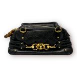 GUCCI Monogram Medium Wave Boston in black, crafted of black Gucci GG leather, solid base, bottom