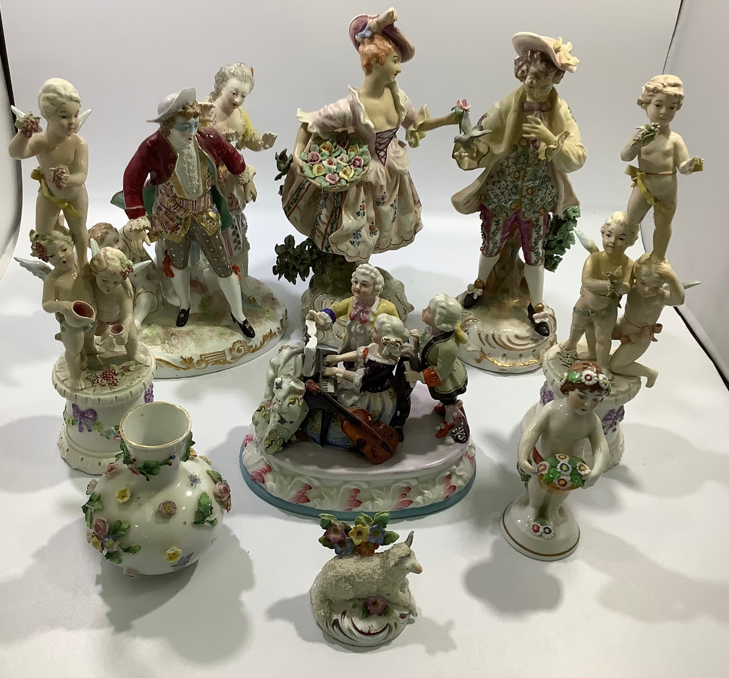 A Meissen porcelain figure group of a couple and a child, the man with blue mask, together with a