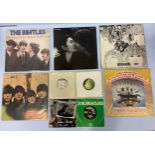 An assorted collection of nine 'The Beatles' and related vinyl LPs and singles in original