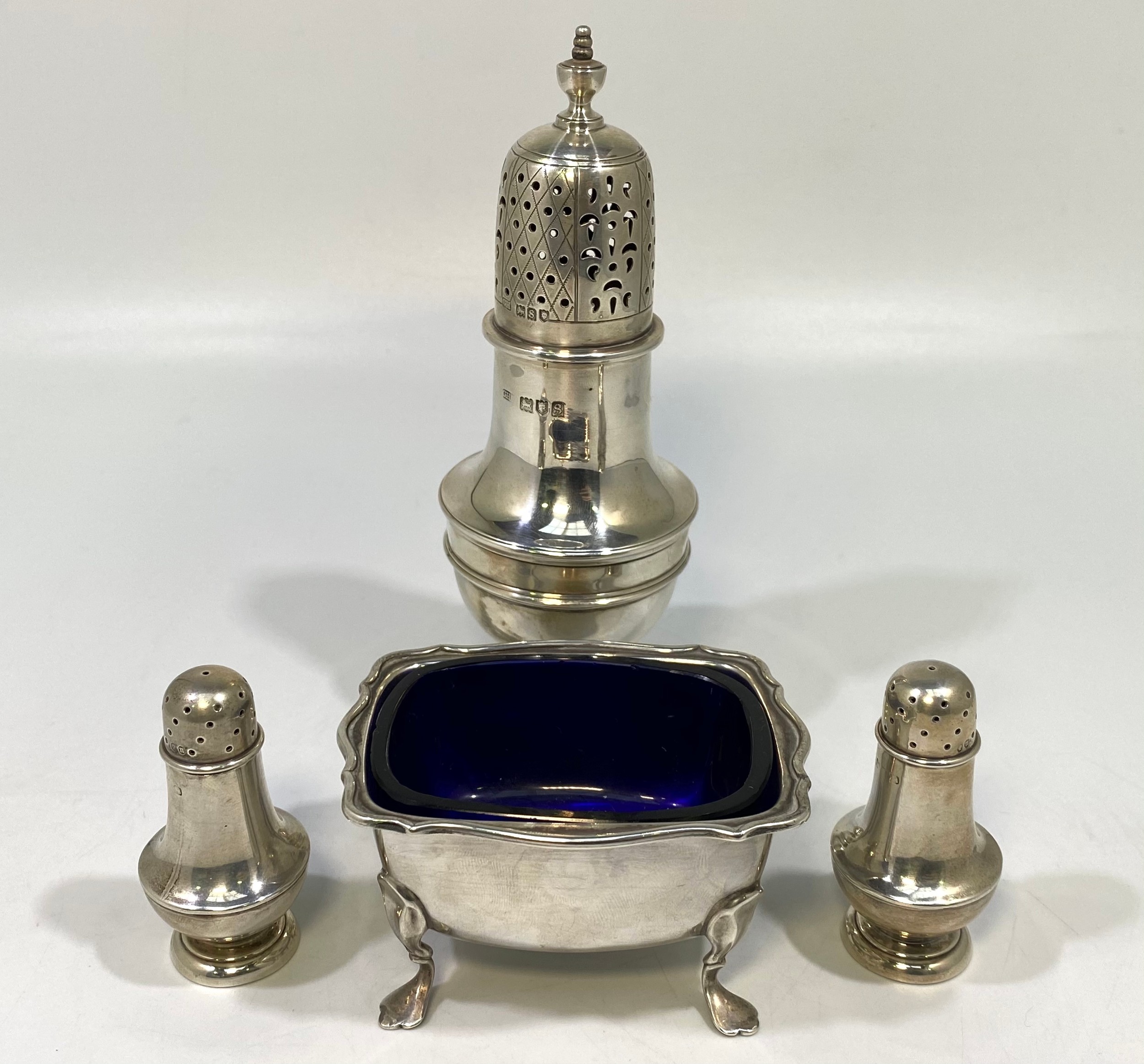 A pair of Victorian silver baluster-shaped peppers, London, 1887, and silver baluster sugar