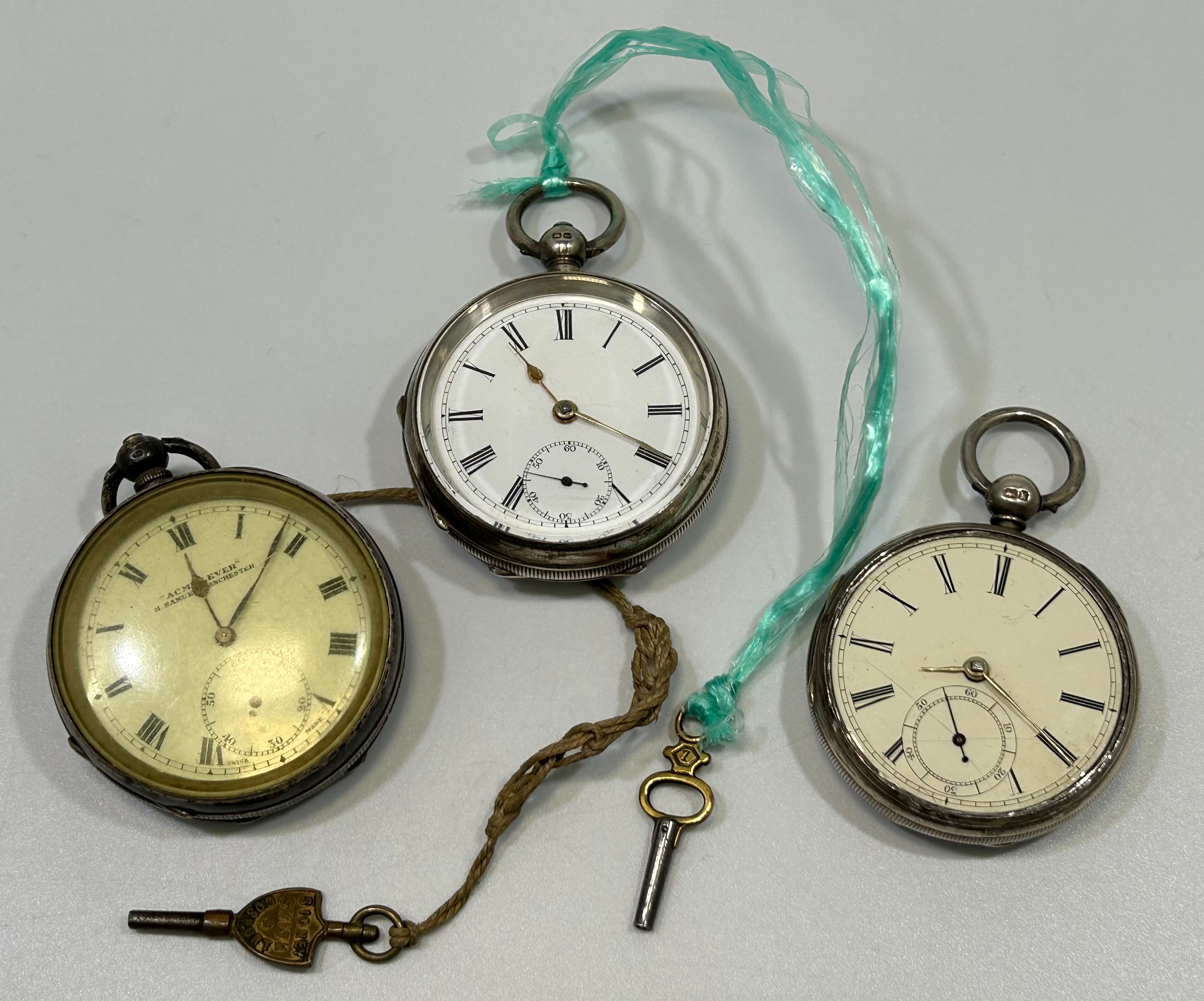 Three various silver-cased open face pocket watches, all with white enamel dials, Roman numerals