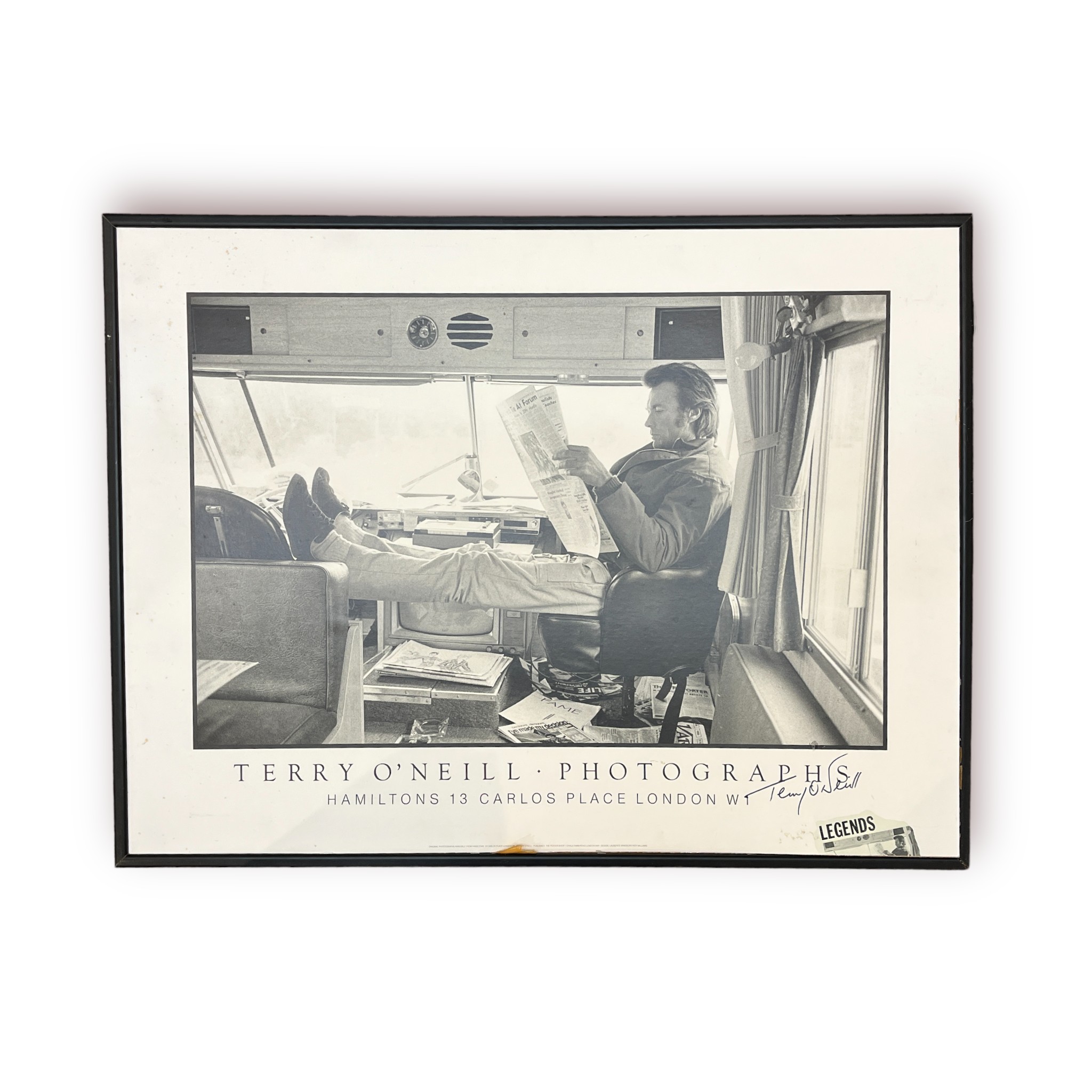 Terry O'Neill (1938-2019), A monochrome printed photograph of Clint Eastwood relaxing in a motorhome