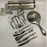 A small collection of assorted silver items comprising a silver-backed mirror, teaspoons,