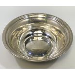 A silver bowl with flared rim, of plain design, marked to base ‘Sterling’ within an infinity