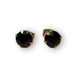 A pair of 9ct gold stud earrings, with round faceted garnets in a 4 x claw setting, together with