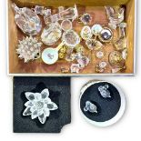 A quantity of Swarovski glass figures, candlesticks, flowers amd bracelet with matching earrings