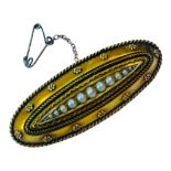 A 15ct yellow gold elongated oval brooch, set with a graduated row of seed pearls to the centre,