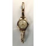 A ladies 9ct gold Cara wristwatch, the silvered dial with Arabic numerals denoting hours and