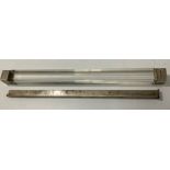 A silver telescopic ruler, together with a silver ended, glass paperweight or possibly ruler' By