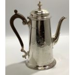 A silver coffee pot by Marples & Co. Of cylindrical tapering form, with crest to one side and