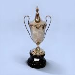 A silver two handled trophy with cover, probably by Henry Williamson Ltd, with inscription, raised
