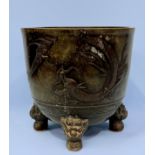A Chinese cast and patinated bronze jardiniere of circular form, cast with two dragons to the