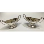 A matched pair of Victorian silver salts by William Hutton & Sons, of oval/trophy form with with